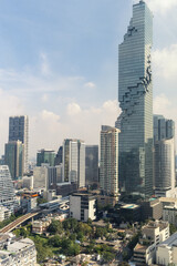 Fototapeta premium Modern city view with high buildings and towers under the blue sky.
