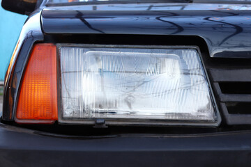 USSR car headlight close-up, black car VAZ 2109, headlight