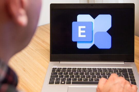 Excharge is used by a man on the laptop. Microsoft customer used computer software. New product is tested by IT specialist. San Francisco, February 2020.