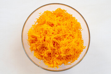 Grated delicious orange pumpkin in a bowl