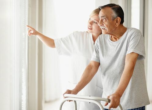 Nurse assisting patient with a walker