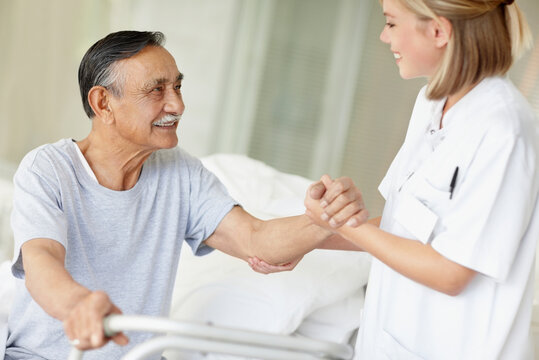 Nurse assisting patient with a walker