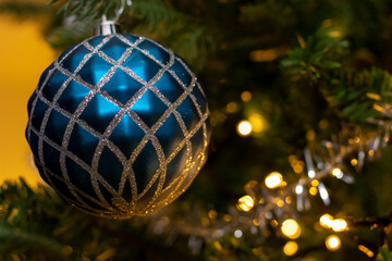 blue glitter baubles in abies normanniana christmas tree
