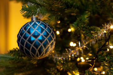 blue glitter baubles in abies normanniana christmas tree