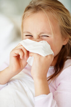Girl (10-11) blowing nose