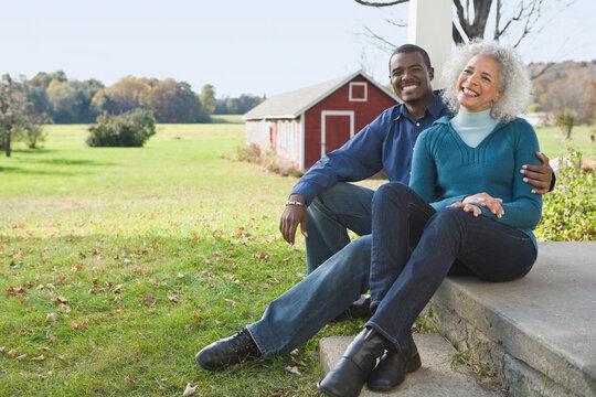 Couple sitting on porch - Powered by Adobe