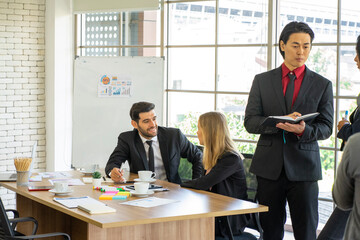 mixed race standing businessman and  colleague presented the project idea in the office  by teleconference online during social distancing work from home