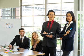 mixed race standing businessman and  colleague presented the project idea in the office  by teleconference online during social distancing work from home