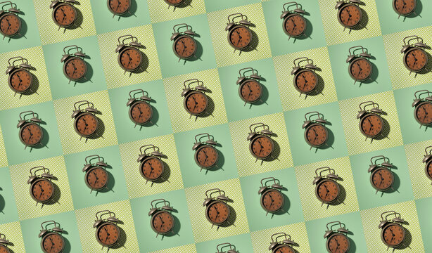 Rows of vintage alarm clocks on green background