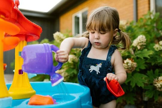 Toddler girl (2-3) playing with water in garden