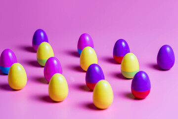 Colorful Plastic Easter Eggs on pink background
