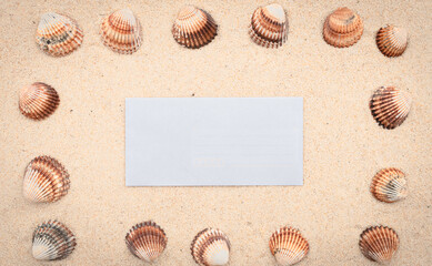 Arrière-plan grains de sable de mer, sable fin de plage avec enveloppe et coquillages. Emplacement pour texte sur papier.	