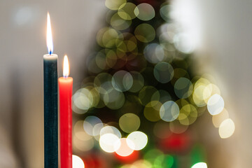 Closeup of burning candles in cozy room on bokeh background during Christmas party