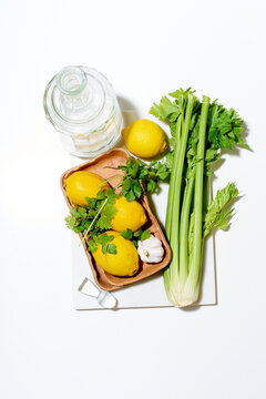Flat lay with lemons, celery and parsley