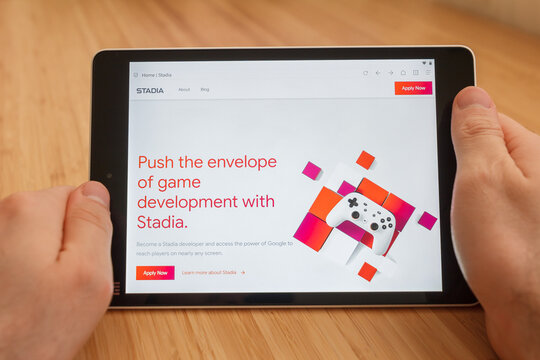 SAN FRANCISCO, US - 1 April 2019: Close up to hands holding tablet using internet and looking through stadia web site, in San Francisco, California, USA. An illustrative editorial image.