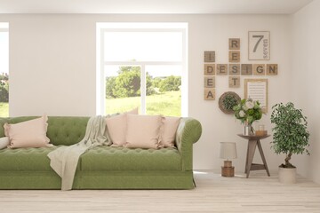 Fototapeta premium White living room with sofa and summer landscape in window. Scandinavian interior design. 3D illustration