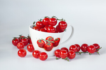 Cherry Tomatoes in a large white Cup. Isolated On White Background