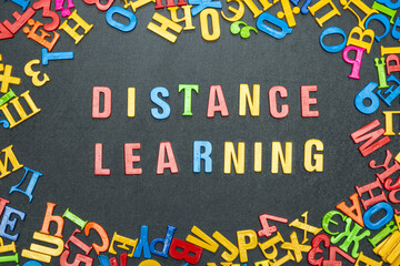 Distance learning, word from bright color letters on black background