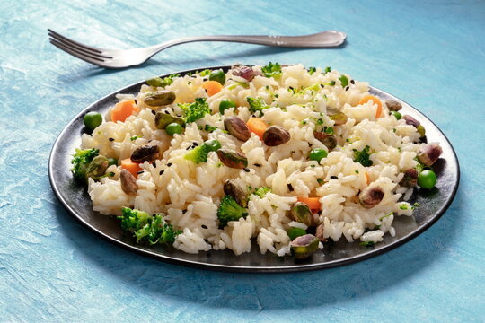 Vegan rice with vegetables, healthy and delicious, on a blue background