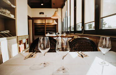 Crystal transparent goblets placed on table setting with tableware in cozy restaurant in Madrid