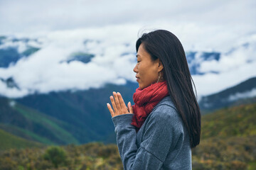 Happy ethnic female hiker in mountain valley