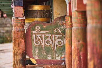 Weathered wooden columns with carved patterns and hieroglyphs placed near old antique temple