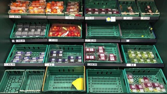 London UK, December 23rd 2020: Tesco fruit and vegetable baskets on shelves. Signs of low supplies to re-stock, cost of living, inflation. Concept for food shortages.