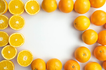 fresh, whole and cut oranges are on the table