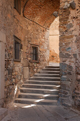 Medieval passageway with stairs in the ancient city of Caceres in Spain.