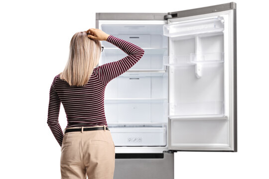 Rear shot of a woman holding her head and looking at an empty fridge