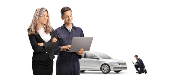 Professional woman and a mechanic with a laptop computer for vehicle check