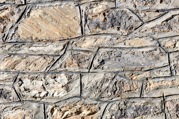 The background old beige wall made of natural stone.