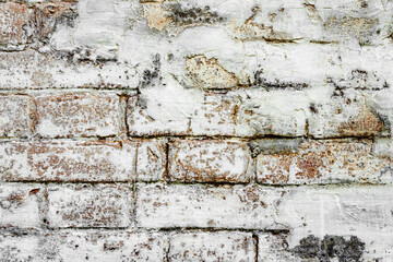Texture of a brick wall with cracks and scratches which can be used as a background
