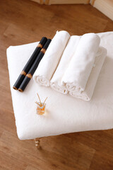 Fototapeta na wymiar bamboo sticks, towels and aroma oil on the massage table