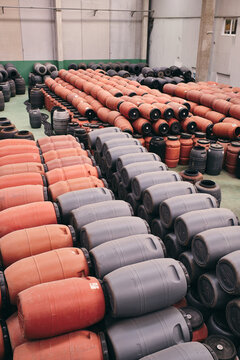 High angle of assorted plastic barrels stored in spacious warehouse in industrial area of factory