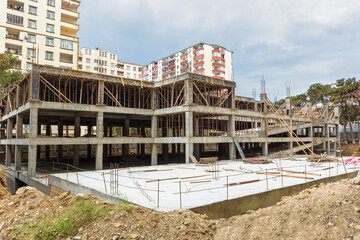 Fototapeta premium Building garage with scaffold at the construction site, exterior view