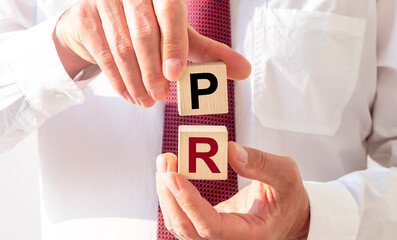 PR acronym inscription on cubes. Public relations concept