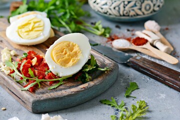 Boiled chicken eggs. The process of cooking boiled marinated chicken eggs with vegetables, herbs, spices and tomato sauce.