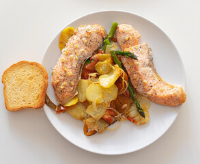 Roast salmon, chips, asparragus, tomatoes and bread dish. Healthy diet.