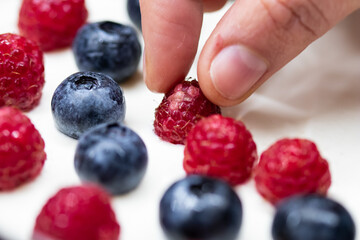 Cheese cake strawberry and raspberry on creamy white flat layer. Cooking at home. Recipe and cooking activity with pastry and bakery. Cheesecake with fruits
