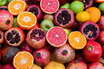 Assortment of fresh juicy exotic fruits bright background