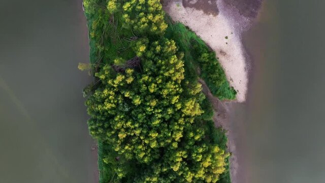 Flight through majestic foggy river Dnestr and lush green island with forest at sunrise time. Dniester canyon, Ukraine, Europe. Aerial UHD 4k drone video