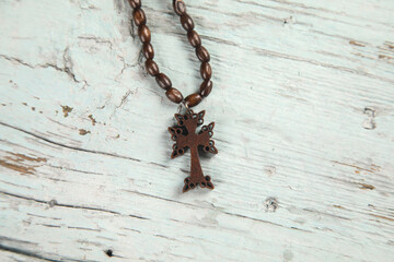wooden necklace cross on table