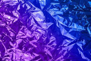 Neon crumpled textured holographic background. High quality photo