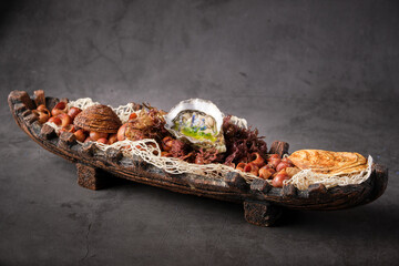 From above palatable oyster in shell served in plate with various seafood ingredients in Asian restaurant