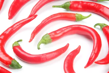 Fotobehang Red hot chili peppers on a white background. food figures. Vitamin vegetable food © photosaint