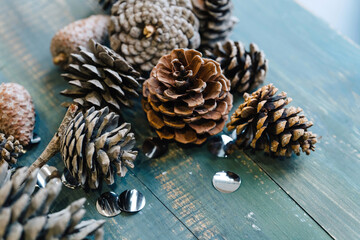 Rustic natural wooden background with pine cones.
