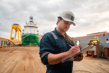 Marine Deck Officer or Chief mate on deck of offshore vessel or ship doing check and filling...