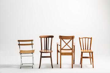 Four classical wooden chairs against white background