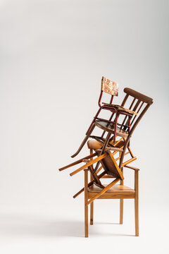 Set of old chairs stacked against white background